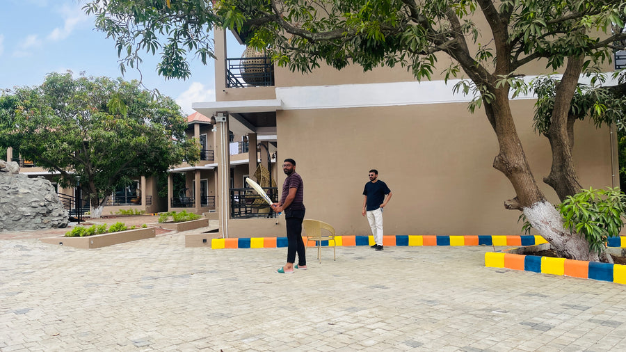 Ambiw team members enjoying an outdoor company outing and play Cricket.