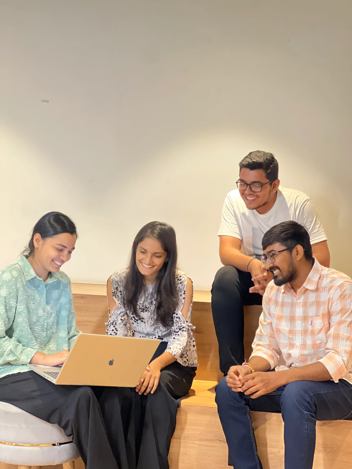 Ambiw team members sharing a happy moment during a creative brainstorming session in the office breakout area.