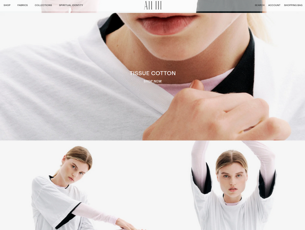 A desktop e-commerce banner for the All Three brand featuring a macro close-up of layered tissue cotton t-shirts