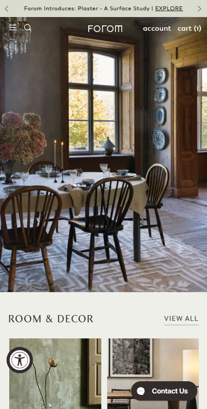 A mobile screenshot of the Forom website homepage showing a rustic dining room setup under the room and decor section.